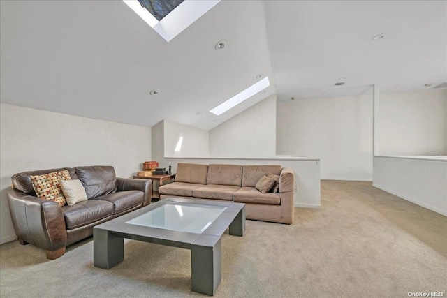 carpeted living room with lofted ceiling with skylight