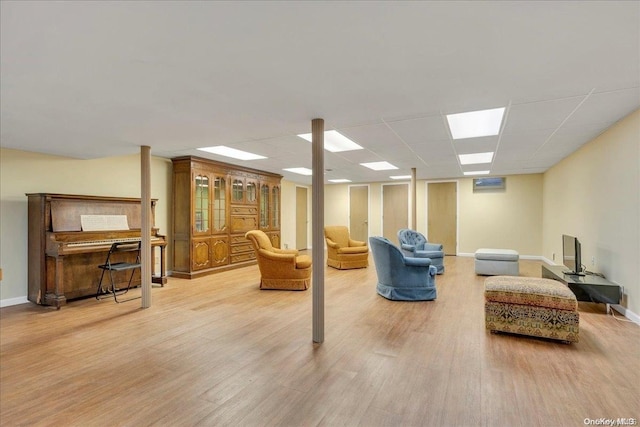 living room featuring a paneled ceiling and wood-type flooring