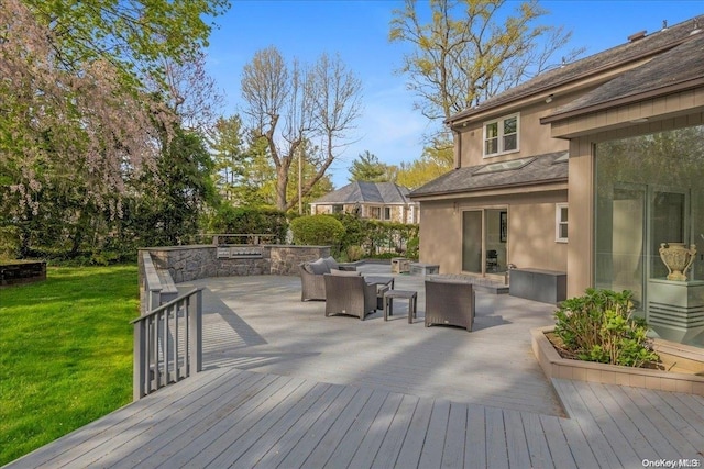 wooden terrace featuring a yard