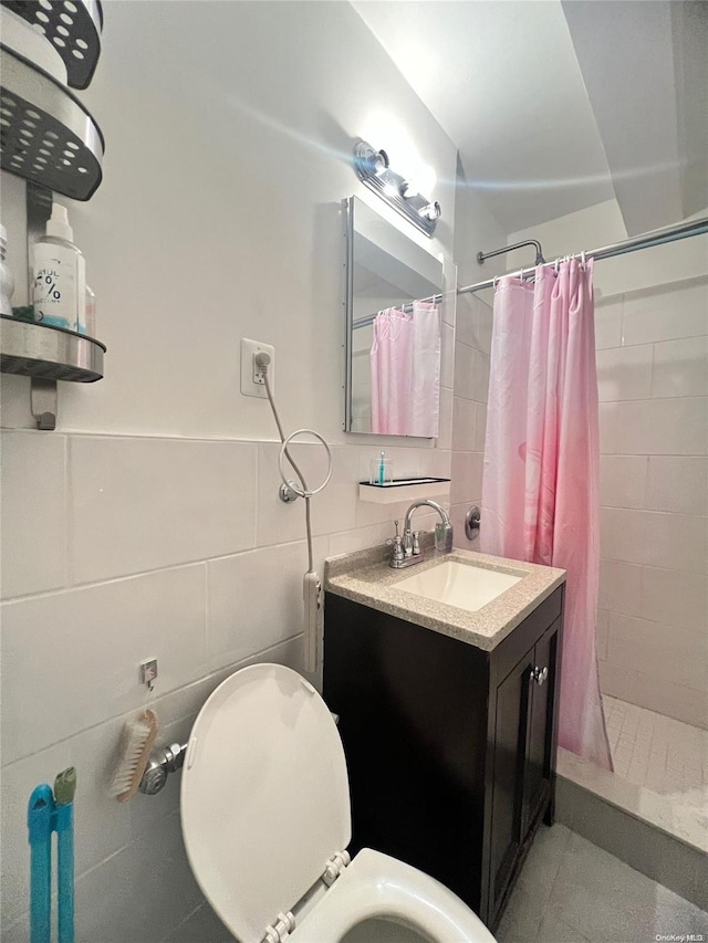 bathroom featuring curtained shower, vanity, tile walls, and toilet