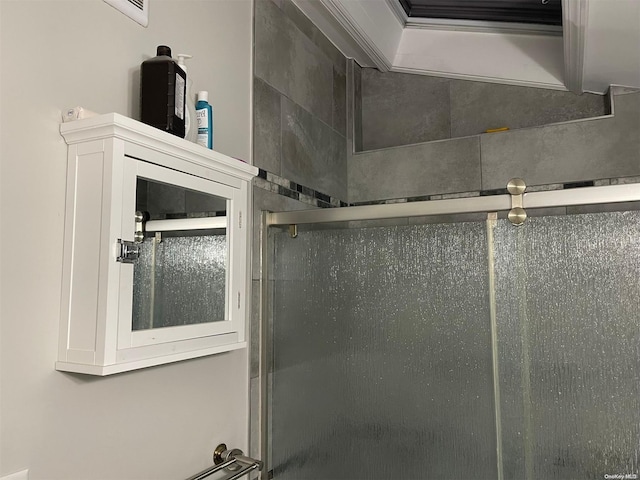 bathroom with a shower with door