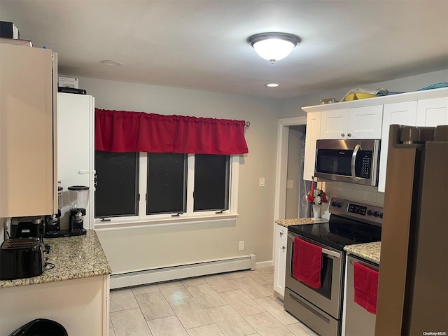 kitchen featuring white cabinets, light stone countertops, appliances with stainless steel finishes, and a baseboard heating unit