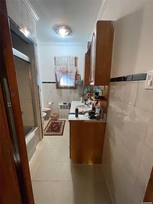 full bath with tile patterned floors, toilet, ornamental molding, tile walls, and vanity