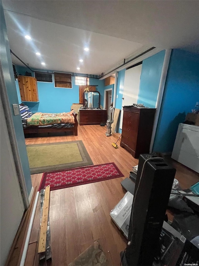 bedroom featuring washer / clothes dryer and hardwood / wood-style flooring