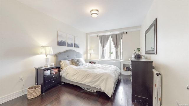 bedroom featuring radiator and dark wood-type flooring