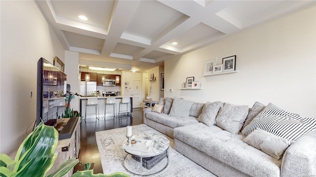 living room with beam ceiling, dark hardwood / wood-style flooring, and coffered ceiling