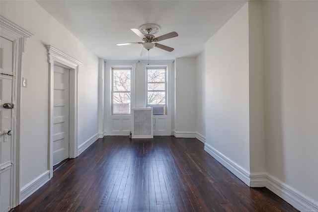 unfurnished room featuring dark wood-type flooring and ceiling fan