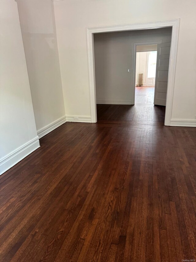 336 74th St, Brooklyn, NY 11209 - unfurnished room with dark wood-type flooring and radiator