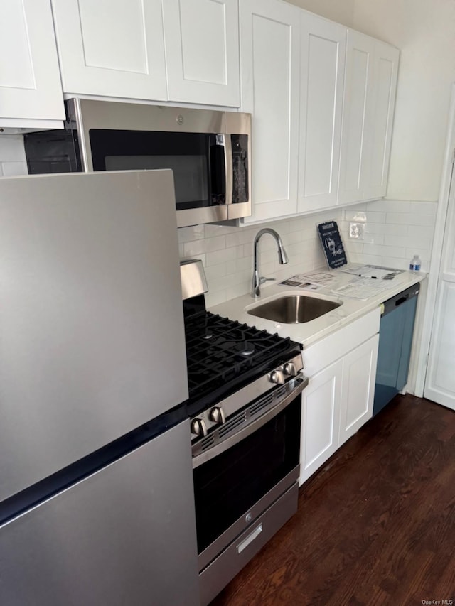 336 74th St, Brooklyn, NY 11209 - kitchen featuring appliances with stainless steel finishes, dark wood-type flooring, white cabinets, and light countertops