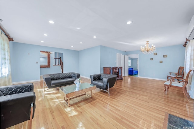 living room featuring light hardwood / wood-style floors and an inviting chandelier