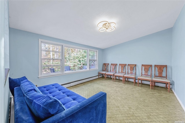 living area featuring carpet, vaulted ceiling, and a baseboard heating unit