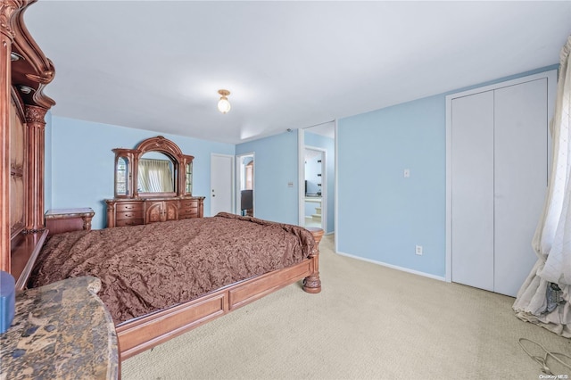 bedroom with light colored carpet and a closet