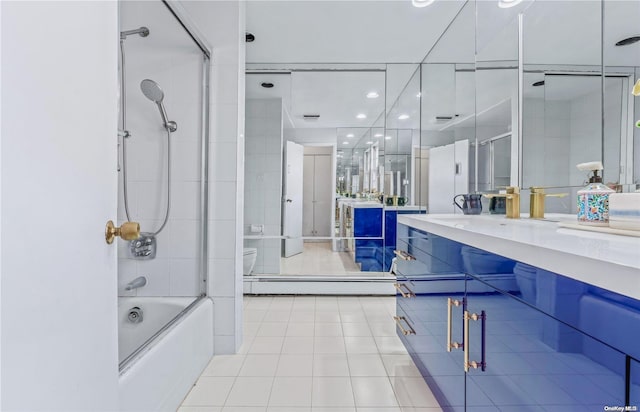 full bathroom featuring vanity, a baseboard radiator, enclosed tub / shower combo, tile patterned flooring, and toilet