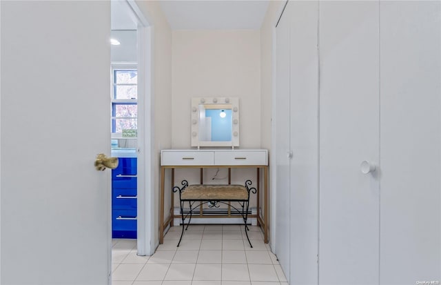 interior space with light tile patterned floors and baseboard heating