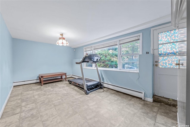 exercise room featuring a baseboard heating unit