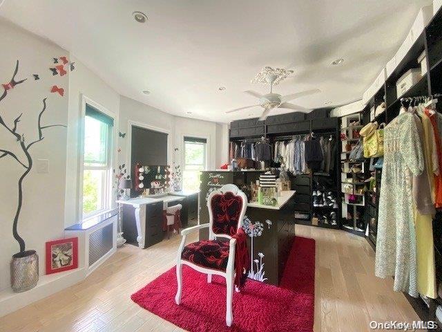 interior space with a wealth of natural light, ceiling fan, and light wood-type flooring