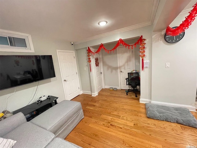 living room with light hardwood / wood-style floors and ornamental molding