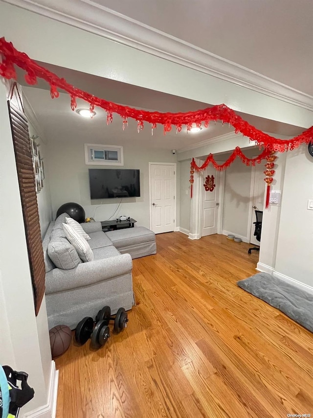 living room featuring hardwood / wood-style floors and ornamental molding