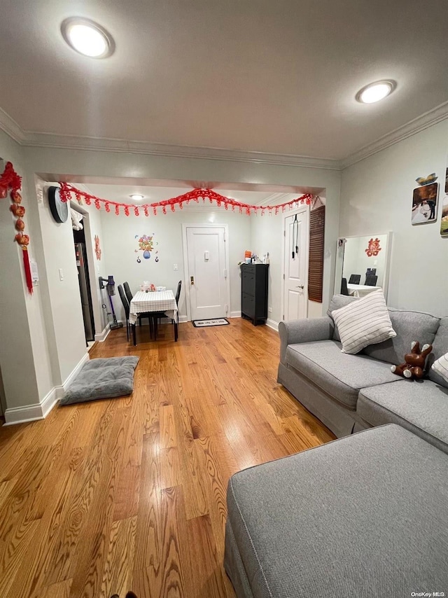 living room with crown molding and hardwood / wood-style flooring