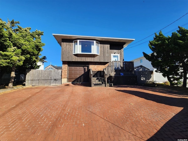 back of property featuring a garage