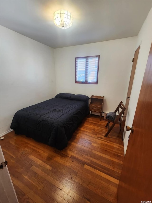 bedroom featuring dark hardwood / wood-style flooring