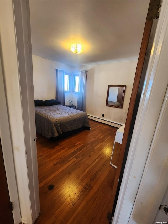 bedroom featuring dark hardwood / wood-style flooring and baseboard heating