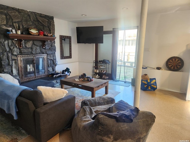 living room featuring a stone fireplace