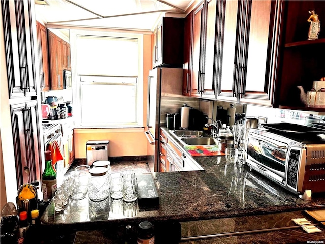 kitchen with dark stone counters and sink