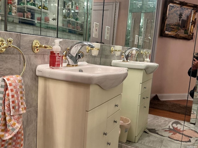 bathroom featuring hardwood / wood-style flooring, vanity, and backsplash