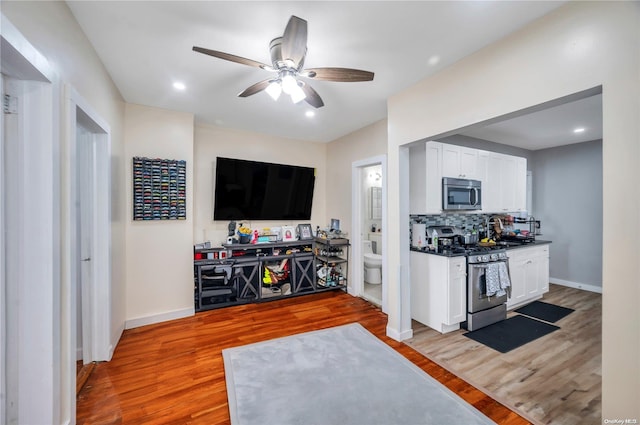 living room featuring light wood-type flooring and ceiling fan