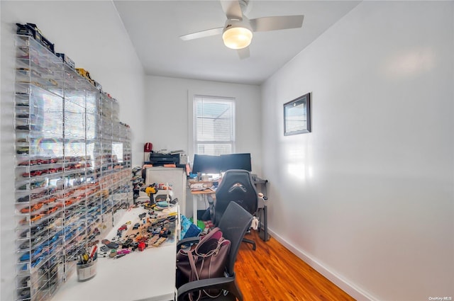 home office with wood-type flooring and ceiling fan