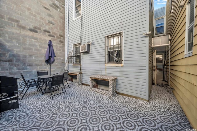 view of patio with an AC wall unit