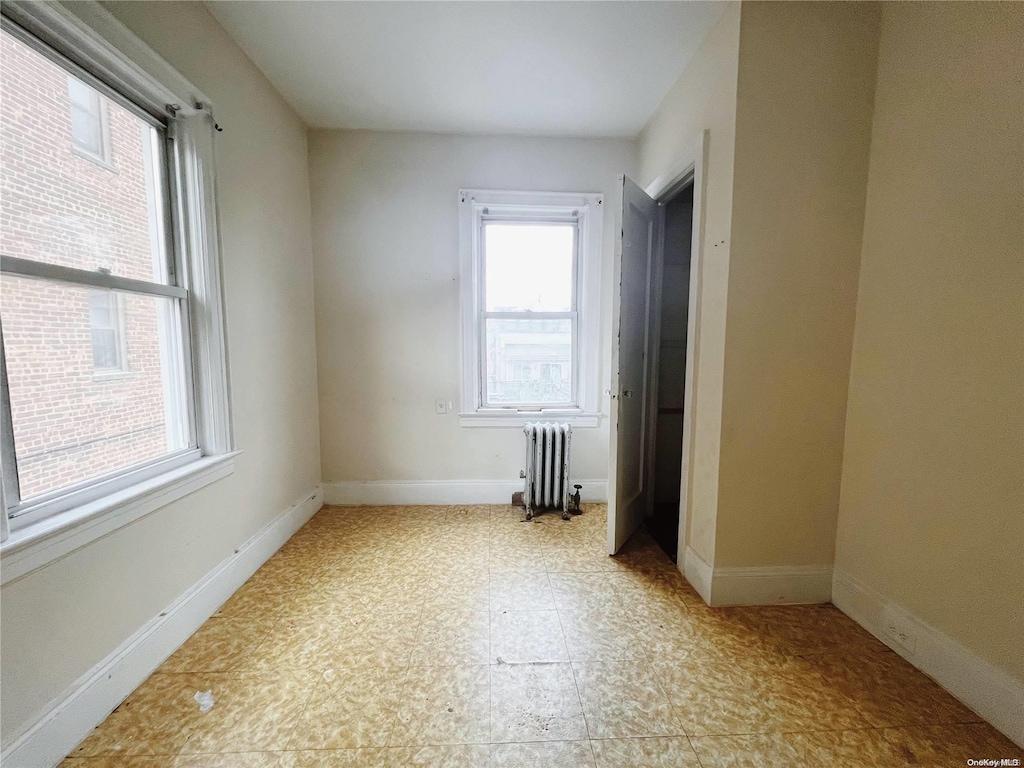 spare room featuring radiator