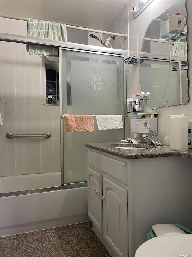 bathroom with shower / bath combination with glass door and vanity