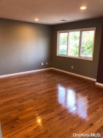 spare room with dark hardwood / wood-style floors