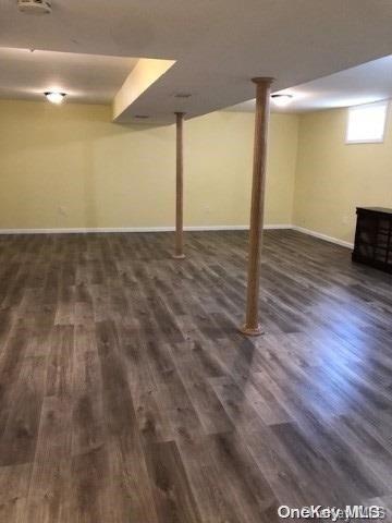 basement featuring dark hardwood / wood-style floors