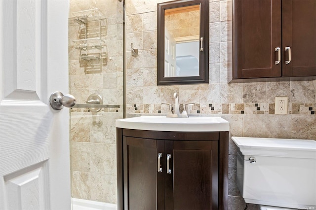 bathroom with backsplash, vanity, and toilet