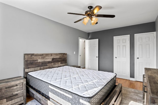 bedroom with hardwood / wood-style floors and ceiling fan