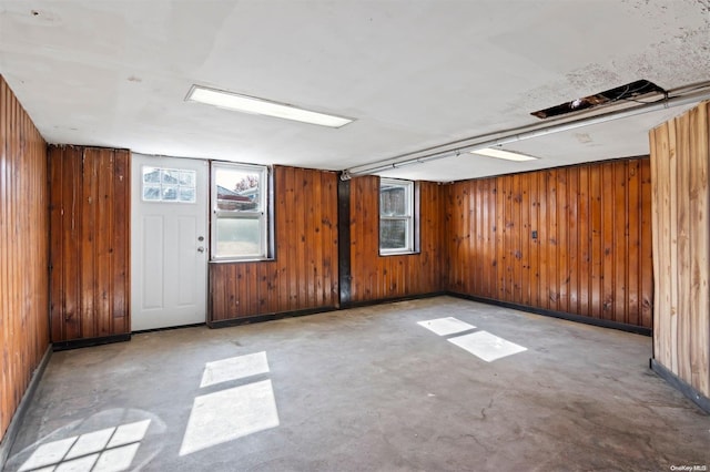 unfurnished room with wood walls