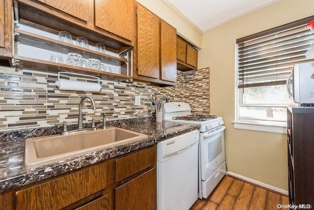 kitchen featuring tasteful backsplash, dark hardwood / wood-style flooring, sink, and white appliances