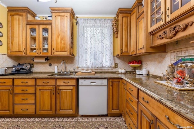 kitchen featuring tasteful backsplash, sink, white dishwasher, and dark stone counters