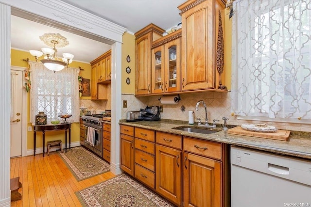 kitchen featuring dishwasher, a wealth of natural light, sink, and high end stainless steel range