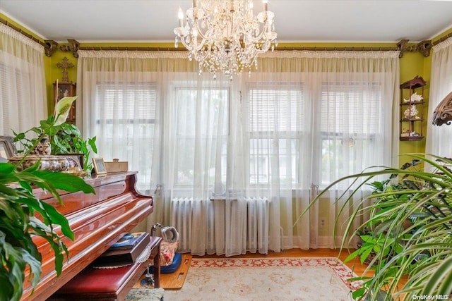 misc room with a healthy amount of sunlight and an inviting chandelier