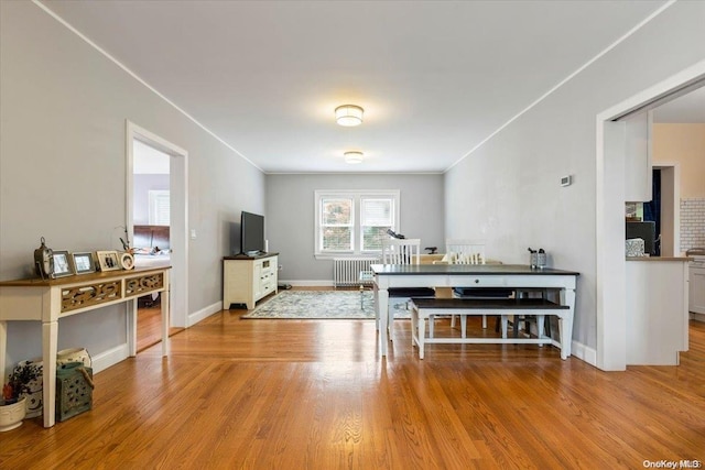 dining room with light hardwood / wood-style floors and radiator