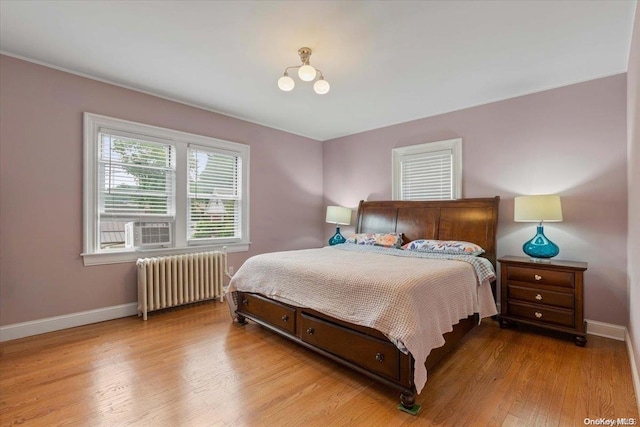 bedroom featuring light wood-type flooring and radiator heating unit