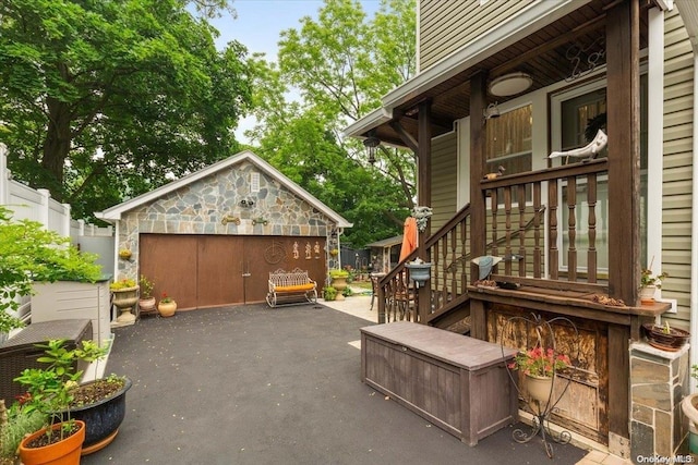 view of patio featuring a garage and an outdoor structure