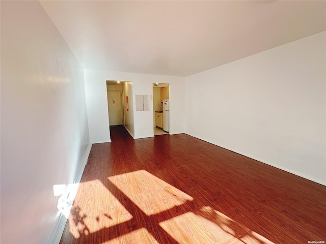 unfurnished room with dark hardwood / wood-style flooring