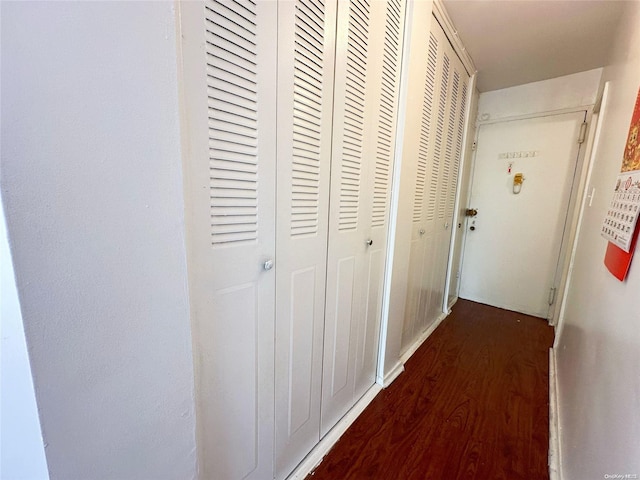 hallway with dark hardwood / wood-style floors