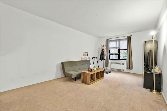 sitting room featuring light colored carpet and radiator