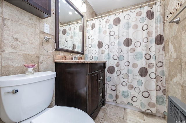 bathroom with tile patterned floors, a shower with curtain, vanity, tile walls, and toilet